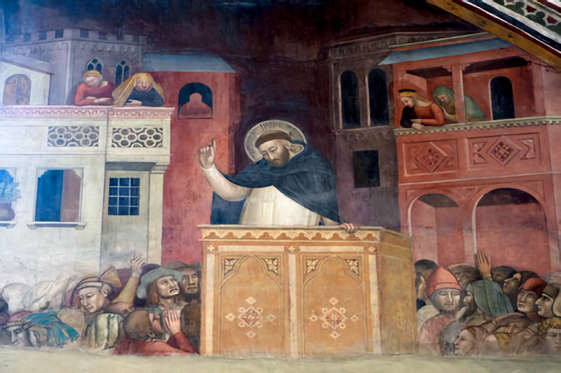 Fresco by Andrea di Bonaiuto showing St Peter Martyr preaching from a wooden pulpit to a dense crowd in a city square, with listeners leaning from the balconies of surrounding palazzi, from the Scenes of the Life of St Peter Martyr, upper entrance wall of the Spanish Chapel, Santa Maria Novella, Florence, 1366-67