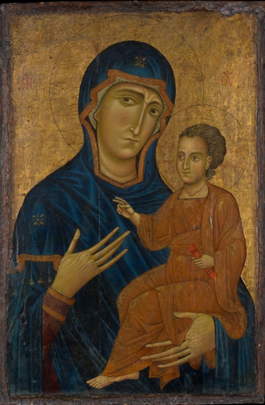 Gold-ground panel with the half-length Virgin in a deep blue mantle edged in orange and marked with gold stars. Her long, narrow face with almond eyes looks out sideways with a melancholy expression. She points with long fingers of her right hand towards the Christ Child, who sits on her left arm in an orange robe hatched with gold, holding a red scroll and raising his right hand in blessing. Red Greek monograms flank the Virgin's head