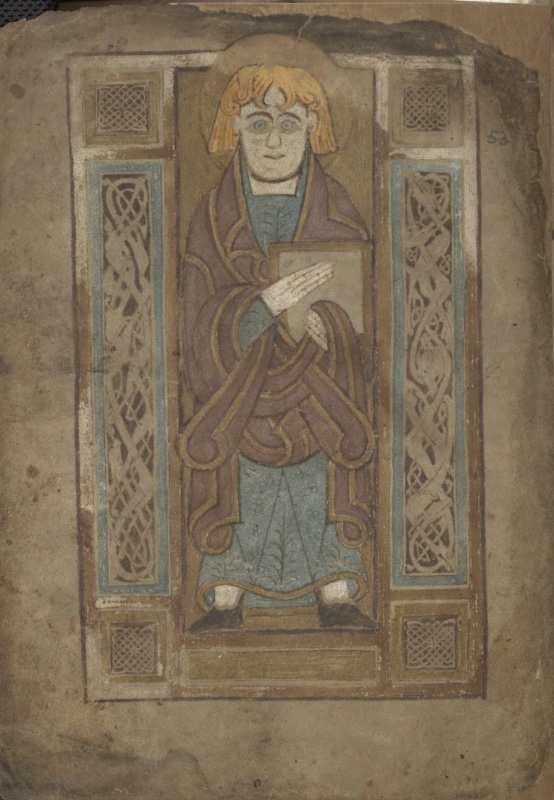Full-page miniature from the Book of Mulling showing a haloed, frontal standing evangelist with orange hair, wearing a mauve cloak over a blue tunic, its folds drawn as interlaced gold-edged bands; he holds a book against his chest with one hand laid flat over it. The figure stands in a rectangular frame with knotwork squares at the corners and tall side panels of interlaced elongated animal ornament on blue grounds; his halo overlaps the top of the frame. The vellum leaf is browned and worn at the edges