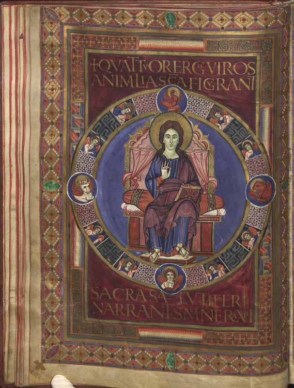 Maiestas Domini page from the Codex Aureus of Lorsch: Christ seated frontally on a cushioned throne within a blue medallion, right hand raised in blessing, a gold-bound book on his knee, encircled by a ring with eight half-length angels and four blue roundels holding the eagle, lion, ox and winged man, all set on a purple field inscribed with gold capitals and framed by jewelled ornamental borders