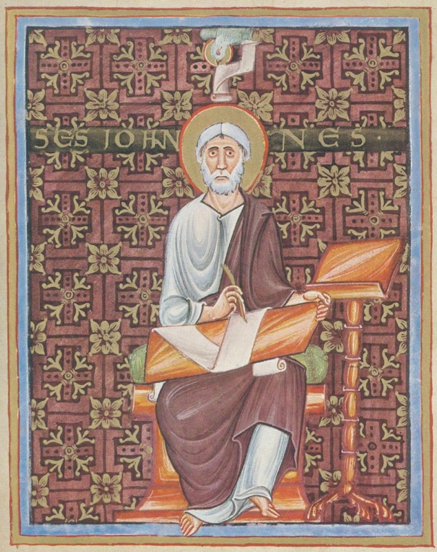 Full-page medieval miniature framed in blue and gold: an elderly white-bearded saint with a gold halo, in a white tunic and dark purple-brown mantle, sits barefoot on an orange seat with a green cushion, writing with a pen on a scroll spread across an orange board in his lap; at right a turned lectern with clawed feet; the red-purple background is covered with a pattern of cross shapes and gold four-petalled flowers, gold letters across it give his name, and at the top a small haloed eagle holds a scroll
