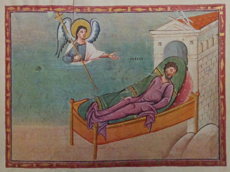 Medieval miniature in a red frame with gold ornament, between lines of text and above red lettering with a large gold initial: against a blue-green sky, a haloed angel with blue-grey wings, in half-length at upper left, holds a cross-topped staff and stretches his open hand towards a bearded man in a violet tunic asleep on a gilded bed with a green cover and red pillow; at right stands a white building with a pediment, an arch and a red tiled roof