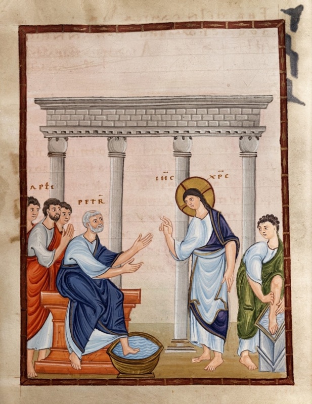 Medieval miniature in a tall red frame, on a pale rose ground with faint show-through writing: beneath a grey colonnade of four columns carrying a masonry entablature, a white-haired man in a white tunic and blue mantle sits on a red seat with one foot in a round basin of water, stretching out both hands; facing him a haloed Christ in a pale tunic and violet-blue mantle stands and raises his hand; behind the seated man stand other apostles, one in red; at right a young man in a green mantle bends to take hold of his raised foot resting on a low block