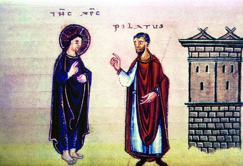Medieval miniature on a pale rose ground with visible ruling above green earth: at left a haloed Christ in long dark robes stands barefoot and frontal, holding two fingers raised before his chest; facing him a bearded man in a white tunic and red mantle raises his index finger; at right stands a tall grey masonry building with small arched windows and twin gabled roofs crowned with crossed finials