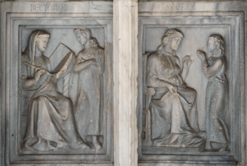 Fontana Maggiore, Perugia: Rhetoric writing in an open book beside a pupil, and Arithmetic teaching finger-reckoning to a standing child