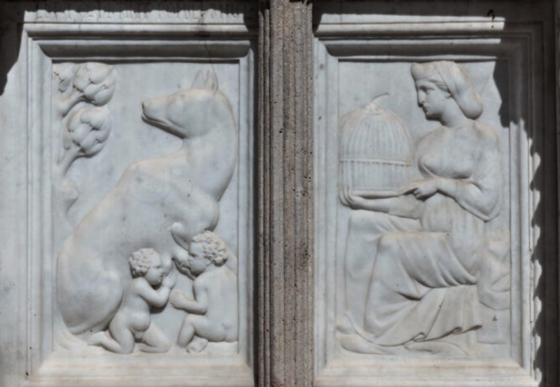 Fontana Maggiore, Perugia: the she-wolf suckling Romulus and Remus beneath a tree, beside Rea Silvia seated holding a birdcage (panel in situ is a copy; original in the Galleria Nazionale dell'Umbria)