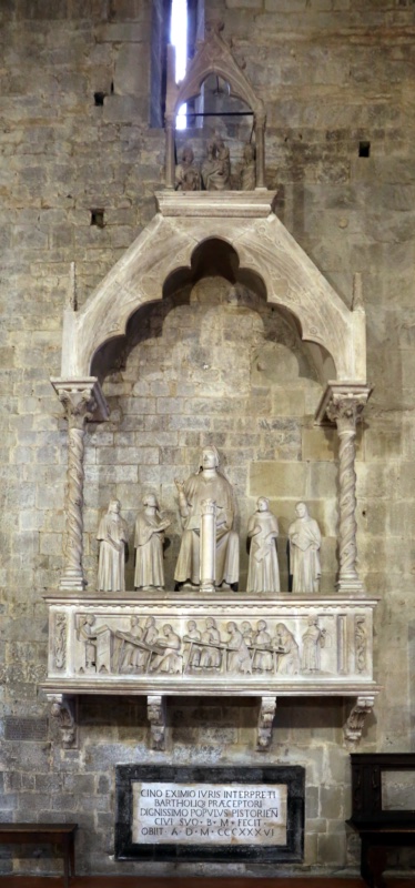 Gothic wall monument of the jurist and poet Cino da Pistoia, attributed to Agostino di Giovanni, 1337–1339: a sarcophagus carved with Cino lecturing to students, statues of the master teaching among four disciples above, under a canopy on twisted columns crowned by an aedicule with the Virgin and Child; Pistoia Cathedral