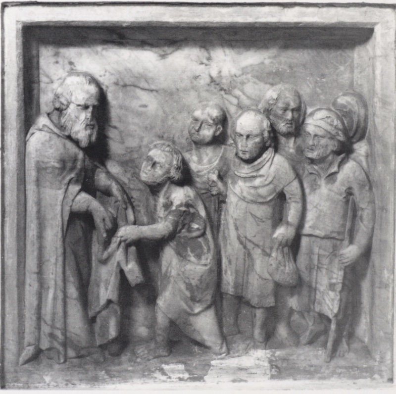 Marble relief attributed to Giovanni di Agostino, c. 1331, from a dismembered saint's shrine in Volterra: an elderly bearded saint at left hands a garment down to a bowing pauper, while five more poor men with staffs, sacks and wrapped heads press forward to receive; Museo Diocesano d'Arte Sacra, Volterra