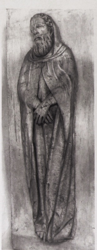 Marble effigy of a dead saint attributed to Giovanni di Agostino, c. 1331, from a dismembered shrine in Volterra: an elderly bearded man in a hooded religious habit lies full length, hands crossed at the wrists on his body, head tilted slightly outward, the drapery running in long parallel folds to the feet; Museo Diocesano d'Arte Sacra, Volterra