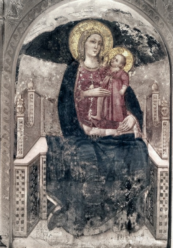 Giuliano da Rimini, Virgin and Child Enthroned, c. 1307-1310, fresco, Oratorio della Madonna del Carmine, Urbania: the Virgin in a dark blue mantle over a patterned crimson dress seated on a Gothic throne with pinnacled uprights and inlaid panels, holding the standing Christ Child in a rose-red tunic who reaches up toward her face, both with gold rayed haloes, within an arched Renaissance frame