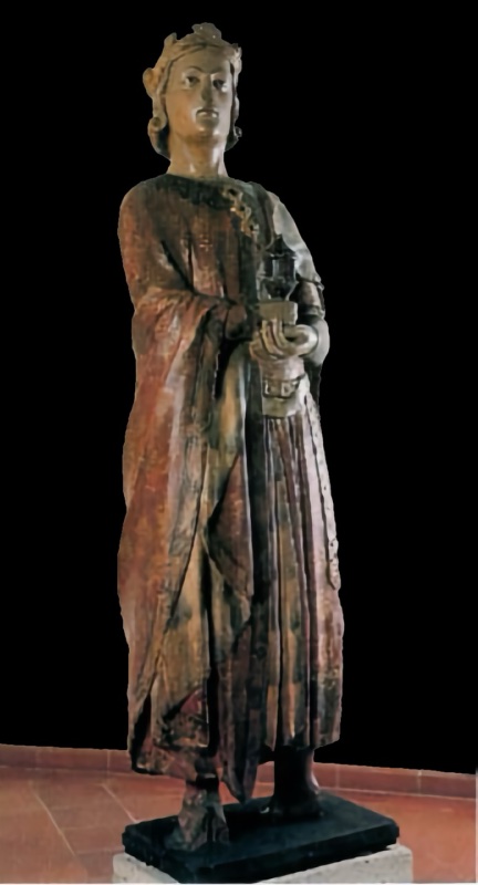 Fourteenth-century life-size painted wooden statue of a young, beardless, crowned Magus standing upright, holding a covered vessel in both hands at his waist; he wears a red mantle with traces of gilding over a finely pleated skirt. Maestro dei Magi di Fabriano, Pinacoteca Civica Bruno Molajoli, Fabriano.