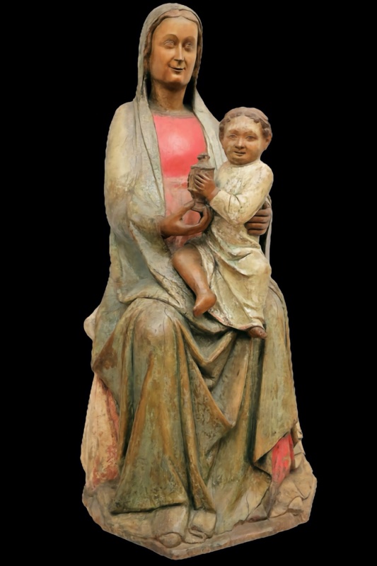 Life-size fourteenth-century polychrome wooden statue of the seated Virgin Mary holding the Christ Child, who clasps a covered vessel and turns to his right; traces of red and green paint survive on the worn surface. Maestro dei Magi di Fabriano, Pinacoteca Civica Bruno Molajoli, Fabriano.
