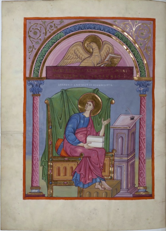 Ottonian manuscript miniature framed by an arch on pink marbled columns with blue foliate capitals; gold vine scrolls fill the mauve spandrels and bands of blue and green leaf ornament run around the arch. In the pink lunette, a haloed golden eagle with raised wings grips a closed book in its talon above a purple band inscribed in gold capitals. Below, against a blue ground, the young, beardless, haloed evangelist John sits on a large jewelled gold throne draped with a green cloth. He wears a blue tunic and a rose mantle, holds closed white books on his lap, raises his left hand with open palm, and looks upward toward the eagle. At right stands a tall arcaded pedestal lectern with a sloping desk bearing an inkwell and quill. A white inscription above reads IOHANNES APOSTOLUS ET EVANGELISTA.