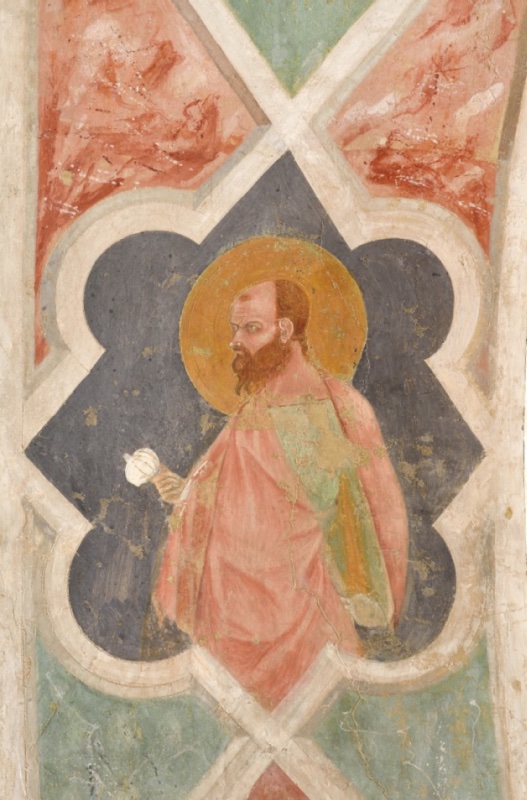Fresco detail from the arch intrados: half-length Saint Paul in profile to the left, bald with a dark beard and stern expression, in a salmon-red mantle over a green tunic, holding a white rounded pommel, within a white quatrefoil on a dark ground surrounded by red and green lozenges