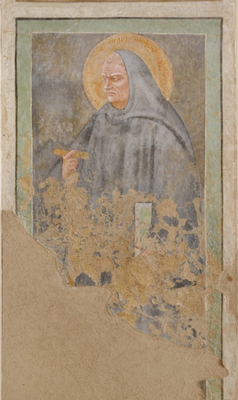 Fresco of Saint Benedict in three-quarter view to the left, wearing a grey monastic hood and habit, gaunt stern face, holding a short rod in his right hand, against a grey ground in a green frame; the lower part is heavily damaged and partly lost