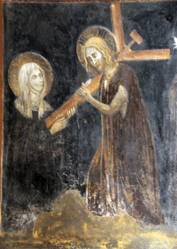 Fresco on a dark blue-black ground. On the right, Christ, haloed, with long fair hair and beard and a sorrowful face, wears a long reddish-brown garment and steps forward with bent knee. He carries a wooden cross on his shoulder, its crossbar and titulus rising behind him, and grips the long shaft with both hands, driving its foot diagonally into the breast of a nun on the left. She stands facing him in a dark habit and white veil, with a golden halo, and lifts her hand beneath the foot of the cross. Christ stands on an ochre mound of ground. The surface is worn, with losses and whitish efflorescence, and part of another figure is visible at the right edge