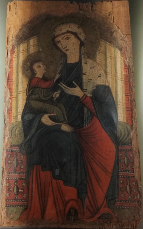 Umbrian painter, possibly Simeone and Machilone of Spoleto, Madonna and Child enthroned, the Virgin in a dark mantle and white veil pointing to the Child who turns to look up at her, c. 1250–70, tempera on panel, Santa Maria Assunta, Otricoli